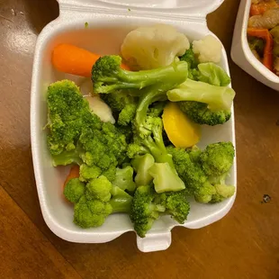 broccoli and carrots in a styrofoam container