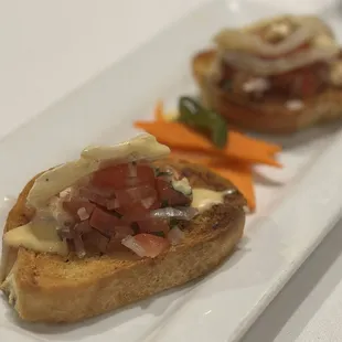 Bruschetta - Perfectly crunchy and seasoned; slightly sweet sauce drizzled over
