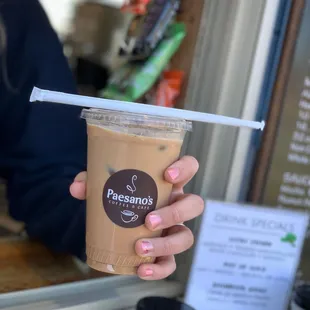 a hand holding a cup of coffee