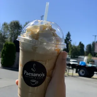 a hand holding a cup of coffee