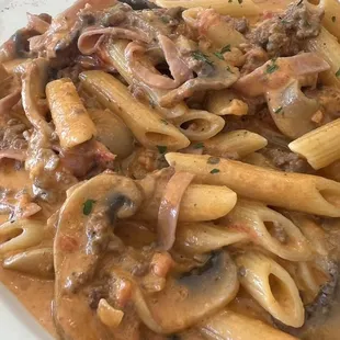 a plate of pasta with mushroom sauce