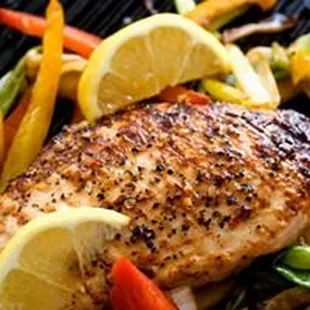 Grilled seasoned fresh chicken breast with assorted vegetables.