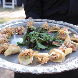 Fried oyster nacho on yucca chip with guacamole passed hors doeuvres