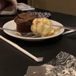 a plate of dessert with ice cream and caramel