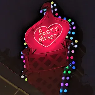 a neon sign for a tasty sweet