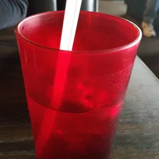 a red plastic cup with a straw sticking out of it