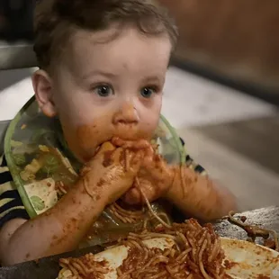 Little boy approves of the spaghetti! Mom and Dad approve of the pizza. Sausage is a must. :)