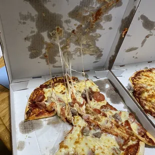 a half eaten pizza in a box