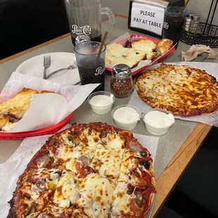 Classic pizza with banana pepper bottom left; Half and half buffalo chicken and super queso pizza