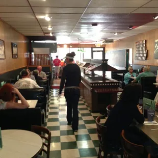 people sitting at tables in a restaurant