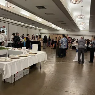 a large group of people standing around tables