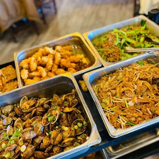 a variety of food in trays on a table