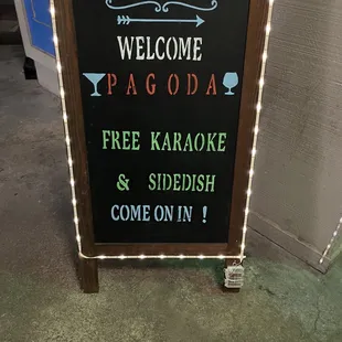 a welcome sign for a free karaoke and sidefish come on in