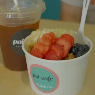 a bowl of fruit and a drink