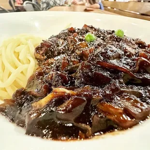 a plate of meat and noodles