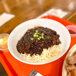 a bowl of noodles and meat