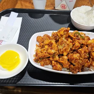 a plate of fried tofu and a bowl of rice