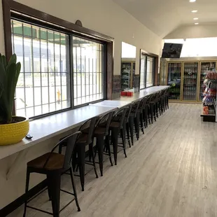 a long table with chairs and a potted plant
