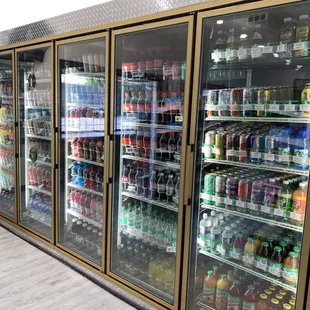 a refrigerated display of soft drinks