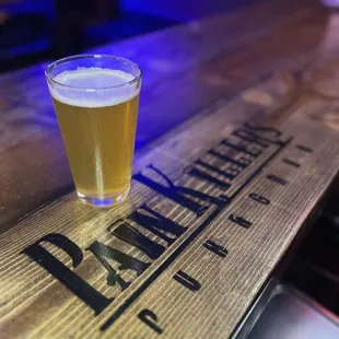a pint of beer on a wooden table