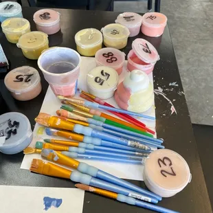 a table with paint and brushes