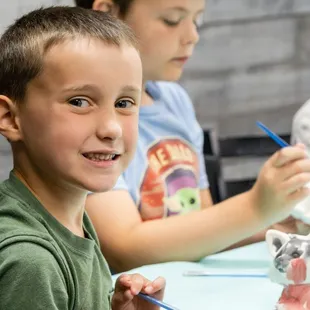 a young boy smiling at the camera