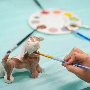 a person painting a dog