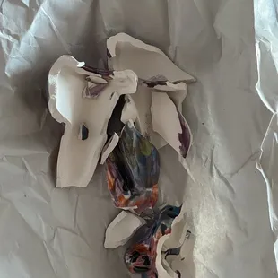 Shattered due to inconsiderate packaging upon pick up. 3 art pieces, (this one being the smallest) crammed into one bag.