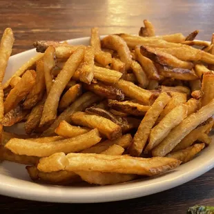 a plate of french fries on a table