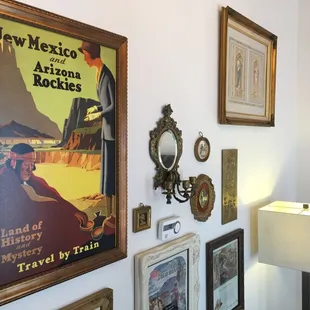 a wall of framed art