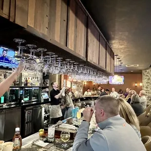 Hanging at the bar getting a drink and some food!