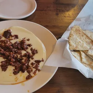 Queso fundido with chorizo and toasted tortilla wedges.