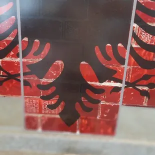 a black eagle on a red background