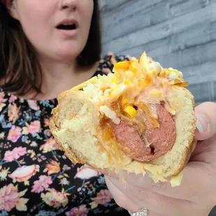 a woman holding a hot dog