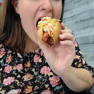 a woman eating a hot dog