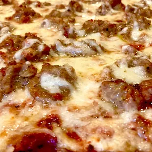 Thin crust, cheese, and sausage pizza