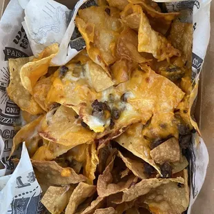 Burned and some soggy Tortillas w/ melted sliced cheese and a few sprinkles of hamburger patty -&quot;Nachos&quot;