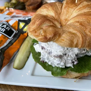 Chicken salad on croissant with kettle chips and pickle