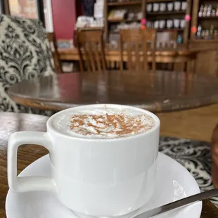 Irish coffee with a dusting of cocoa powder.