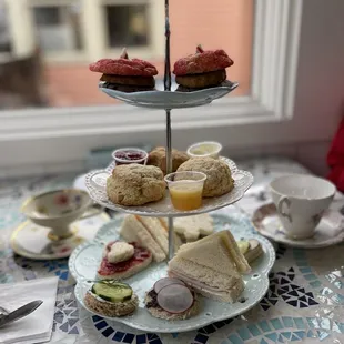 three tiered trays of sandwiches and pastries