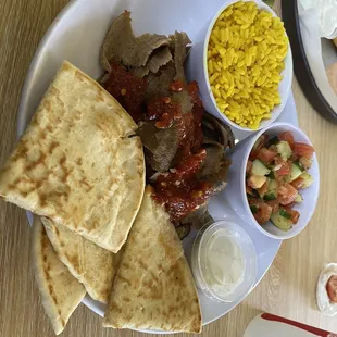 Lamb platter with Tumeric Lemon rice, cucumber tomato salad and pita. Meze trio! Fantastic lunch