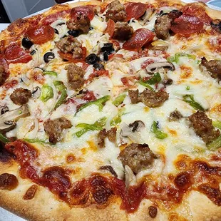 Super Pizza, made to order with half and half toppings to fit our tastes. 12 in is the small... more than enough for two.