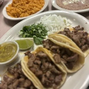 Asada tacos with a side order of rice and substitute charro beans for refried.