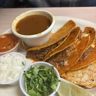Birria plate . Red salsa is spicy but add the lime and it pairs perfectly.