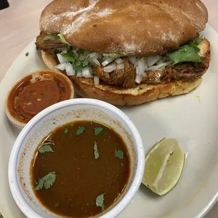 Birria Torta with consomè and spicy salsa. The bolio bread is soft and light, not dense and heavy, and the birria is the best I have had!