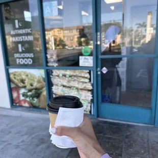 a person holding a cup of coffee