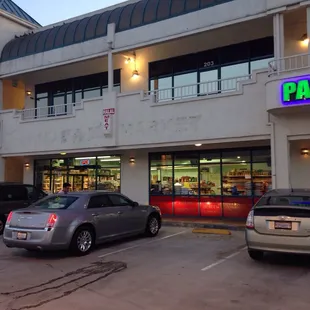 a parking lot with cars parked in front of it
