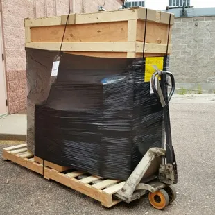 Crate and boxes on a pallet ready for pickup by an LTL carrier.