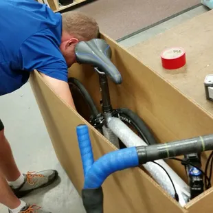 Certified bicycle mechanic packing a customer's bike for shipping.