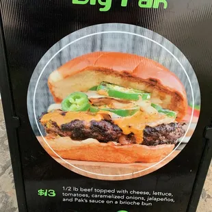 a picture of a burger with cheese and lettuce